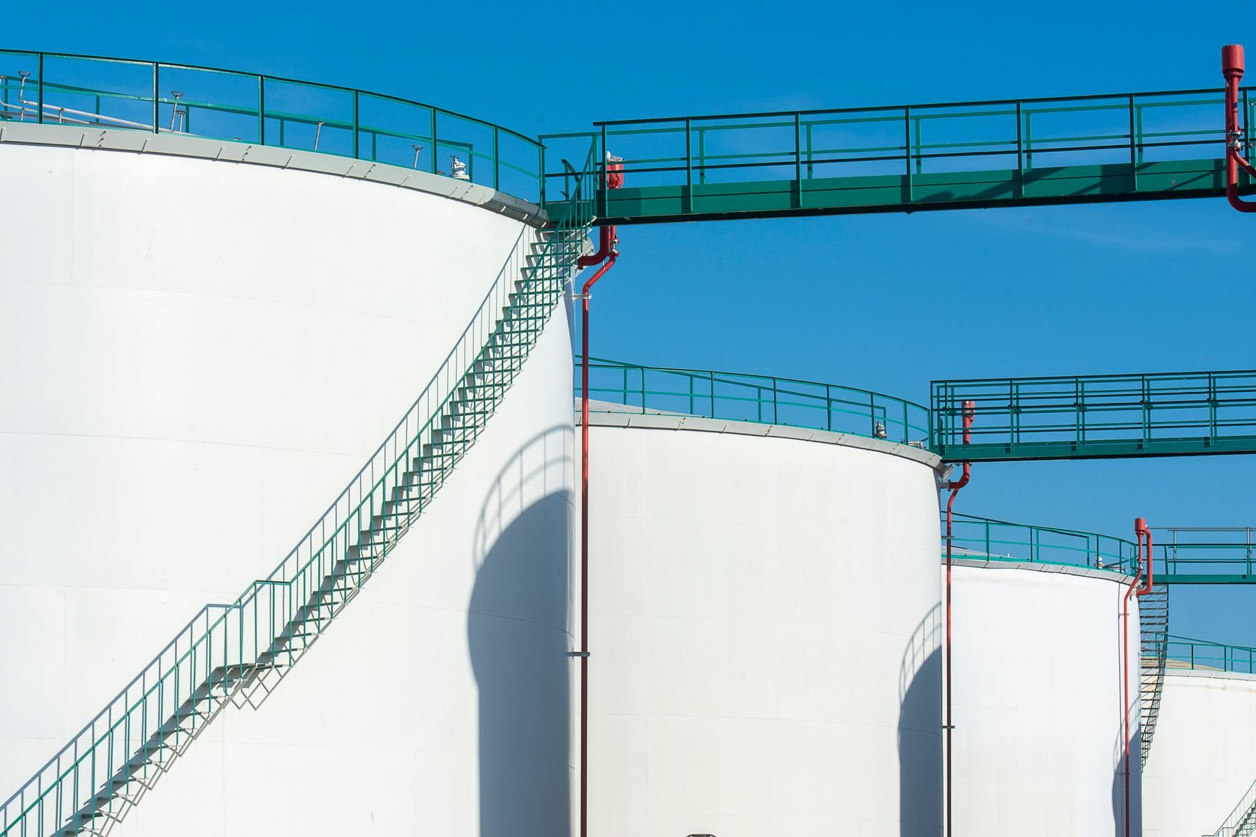 Industrial storage tanks with elevated service walkways