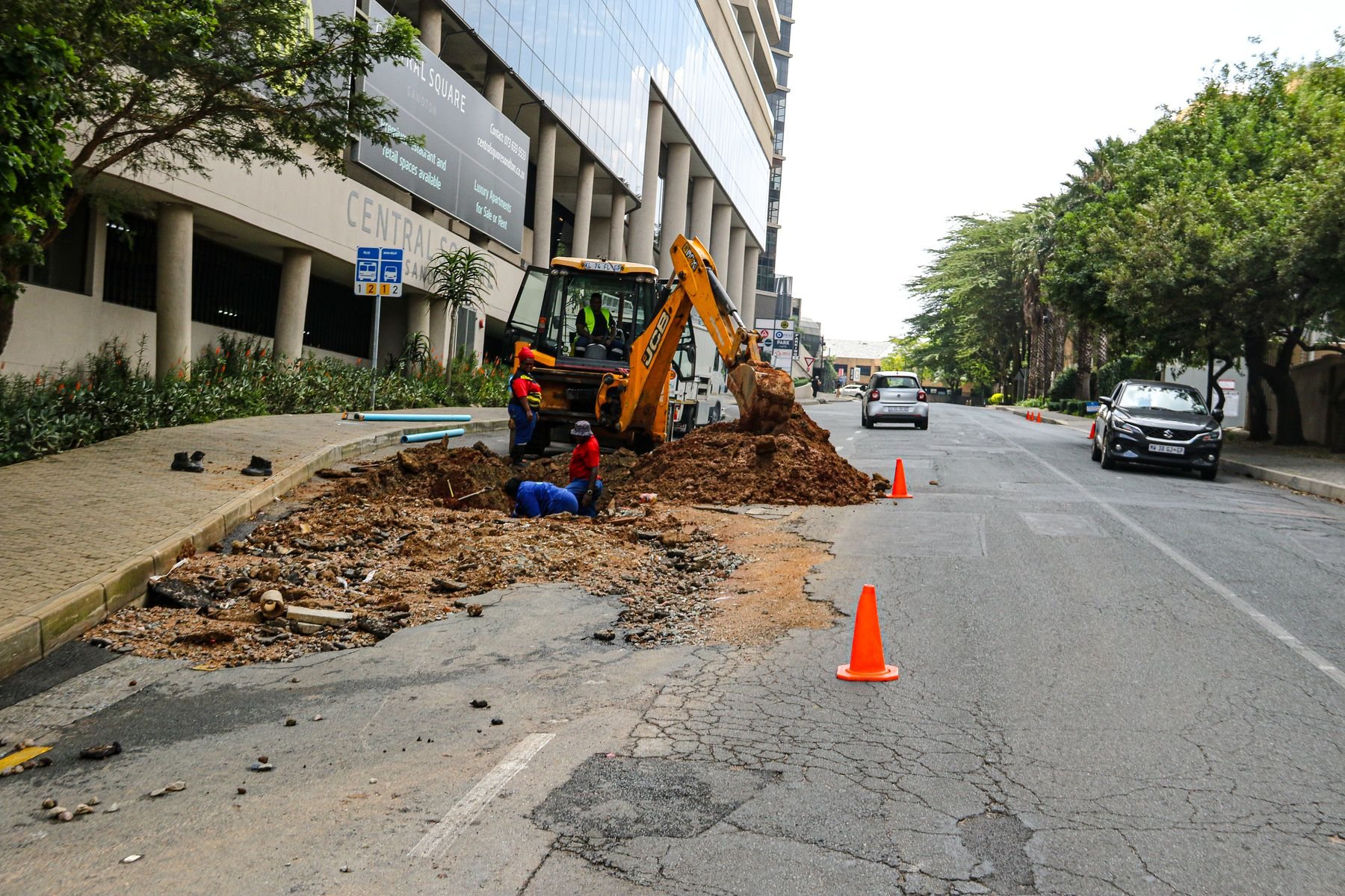 Road construction equipment and workers in Sandton, South Africa